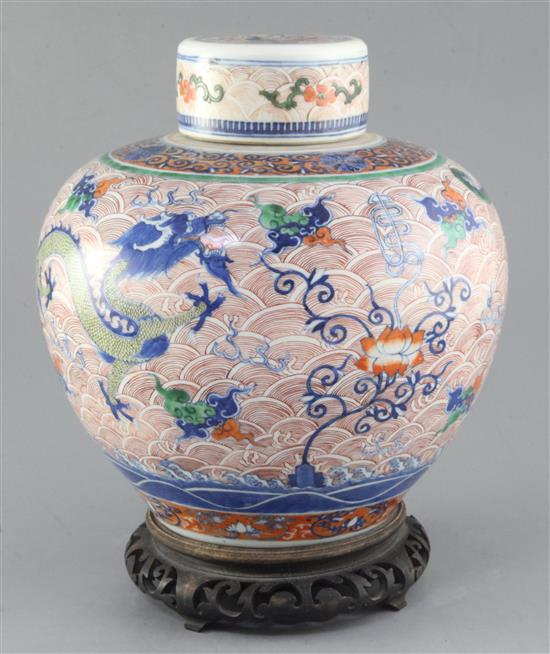 A Chinese doucai dragon ovoid jar and cover, Yongzheng four character mark but 19th century, height 24.5cm excl. wood stand